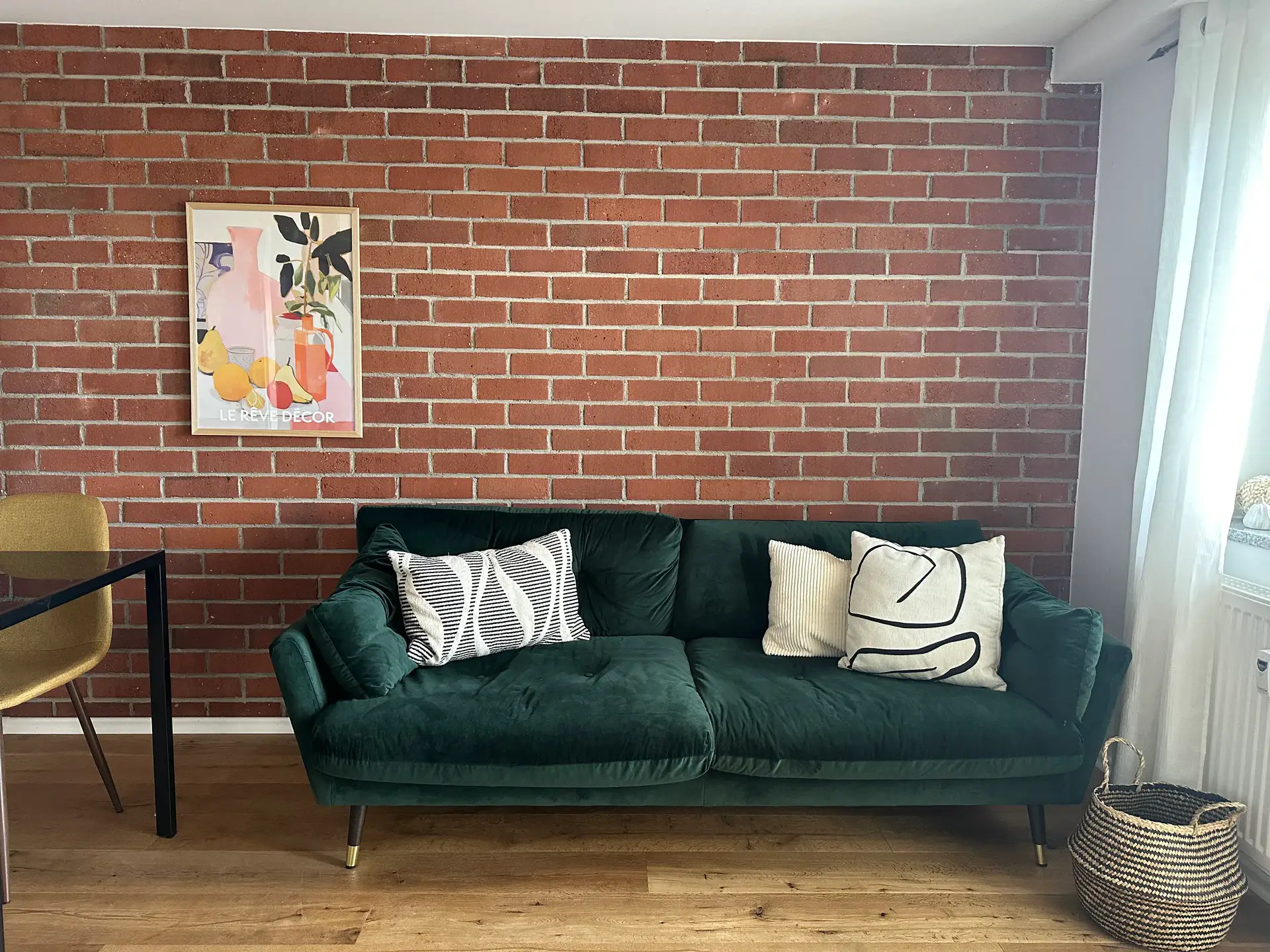 Apartment B6 – Velvet sofa against a brick wall